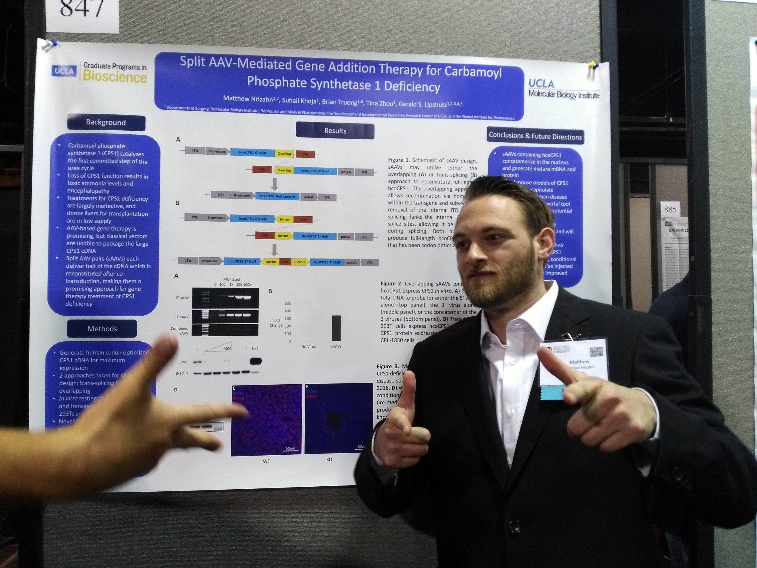 Matt posing in front of his poster during the 2018 ASGCT Meeting