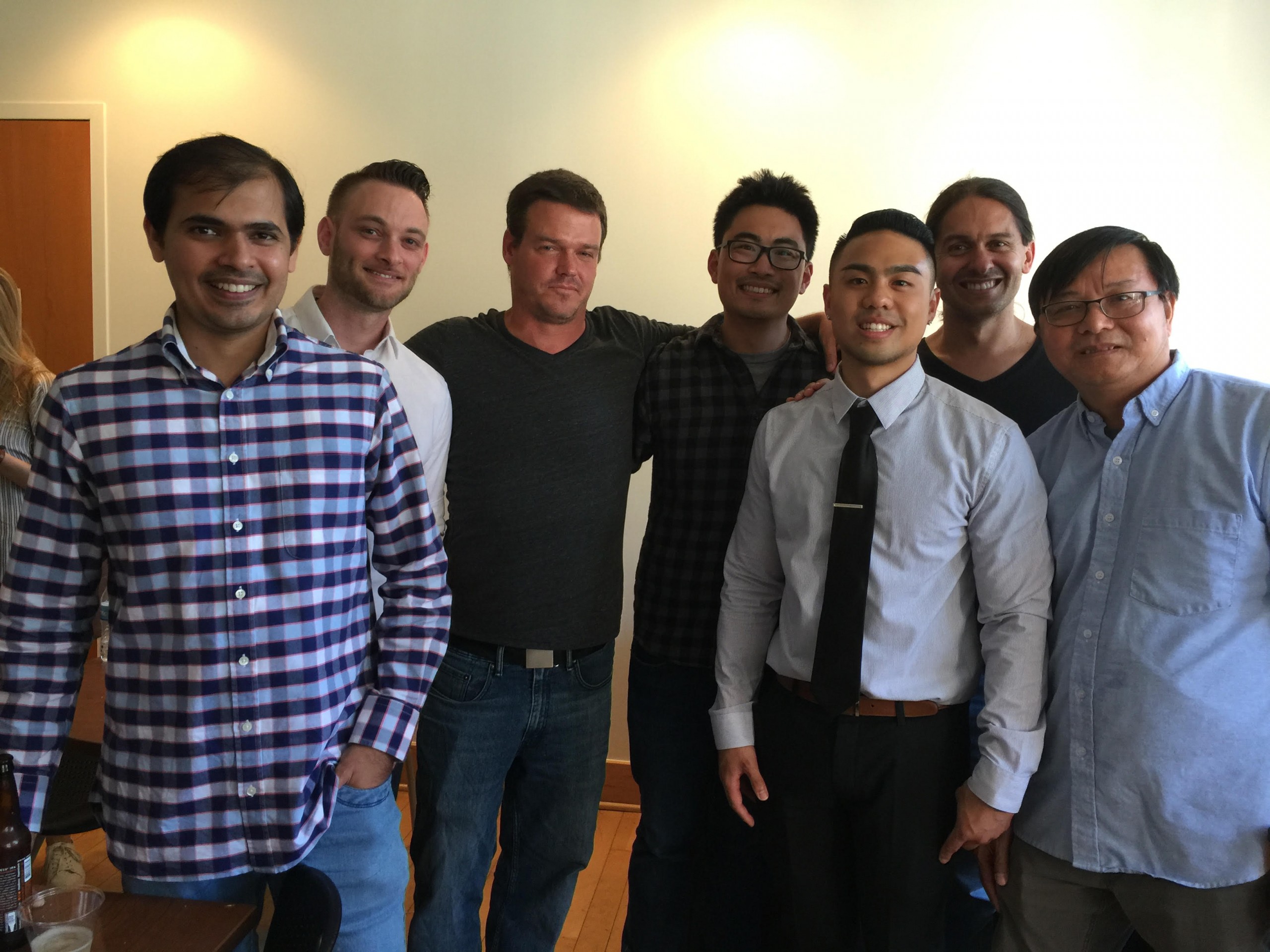 A group of lab members posing after Brian Truong's (third from right) dissertation defense