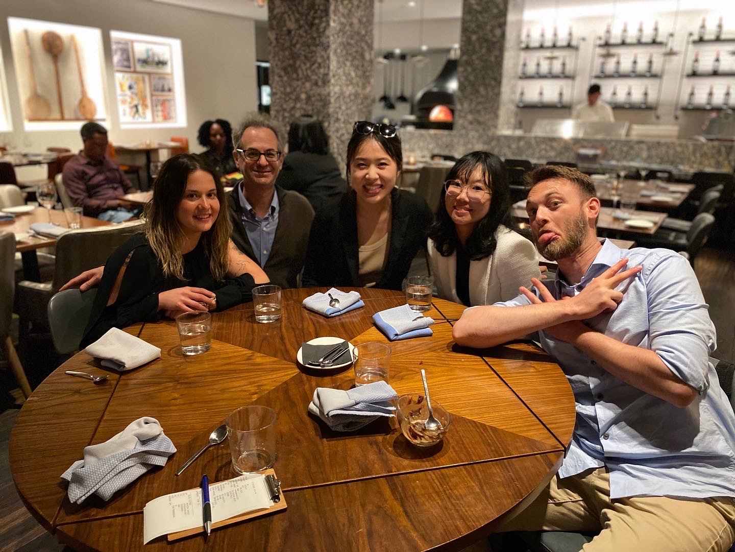 Several members of the lab posing for a picture at dinner