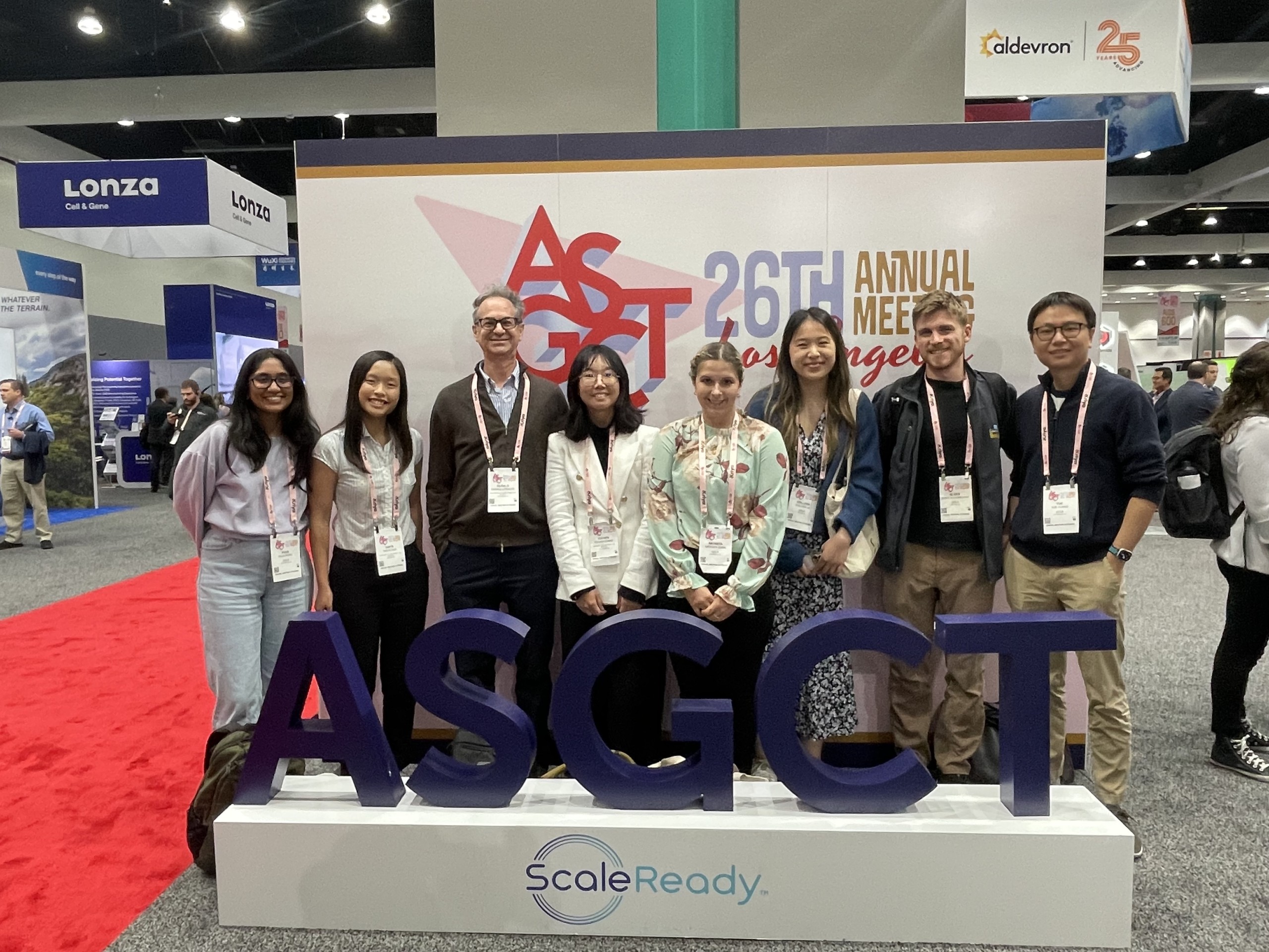 Several members of the laboratory posing in front of an "ASGCT" sign at the 2023 ASGCT Meeting in Los Angeles