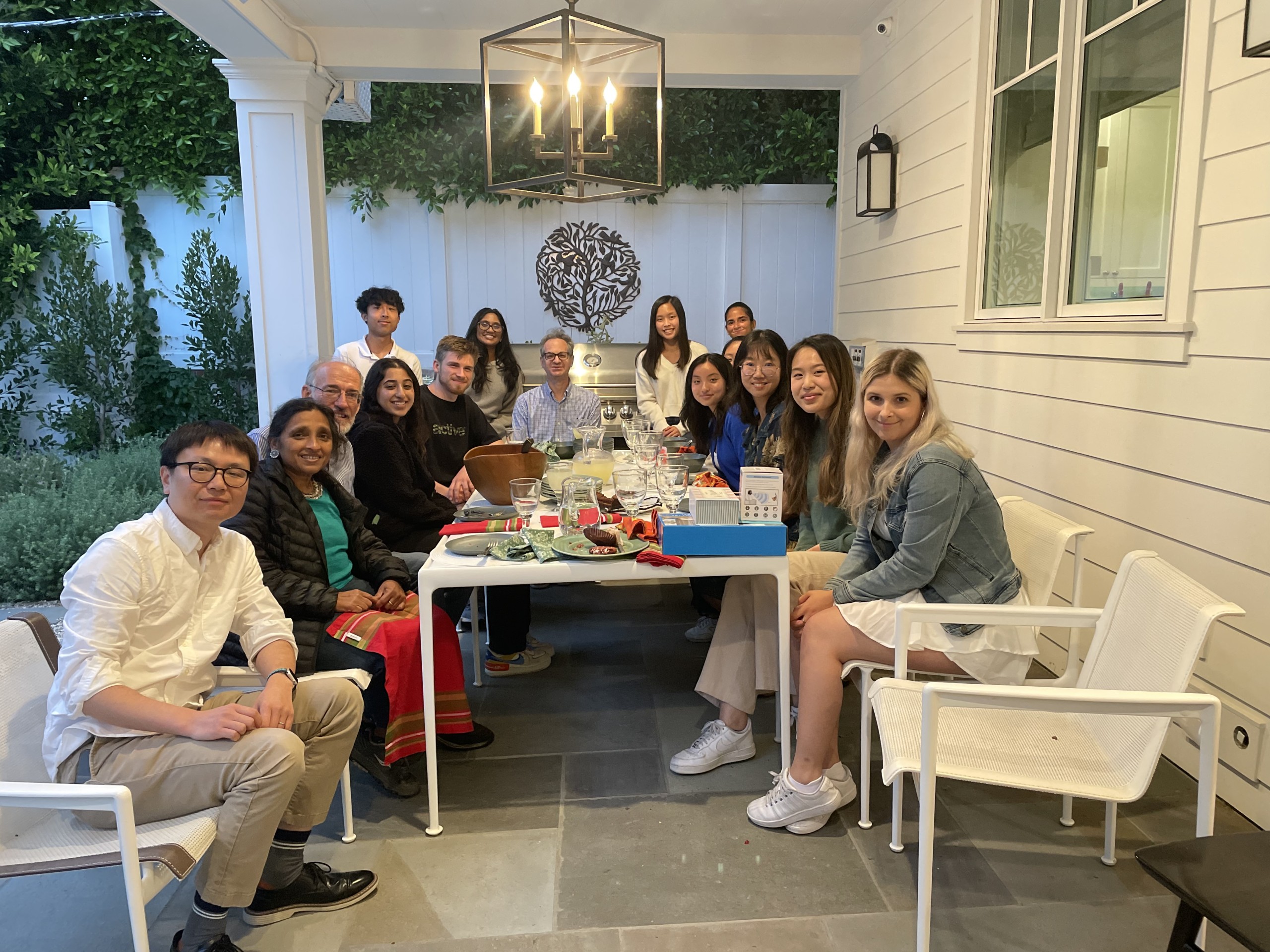 A group of people associated with the laboratory posing for a picture together after having dinner.