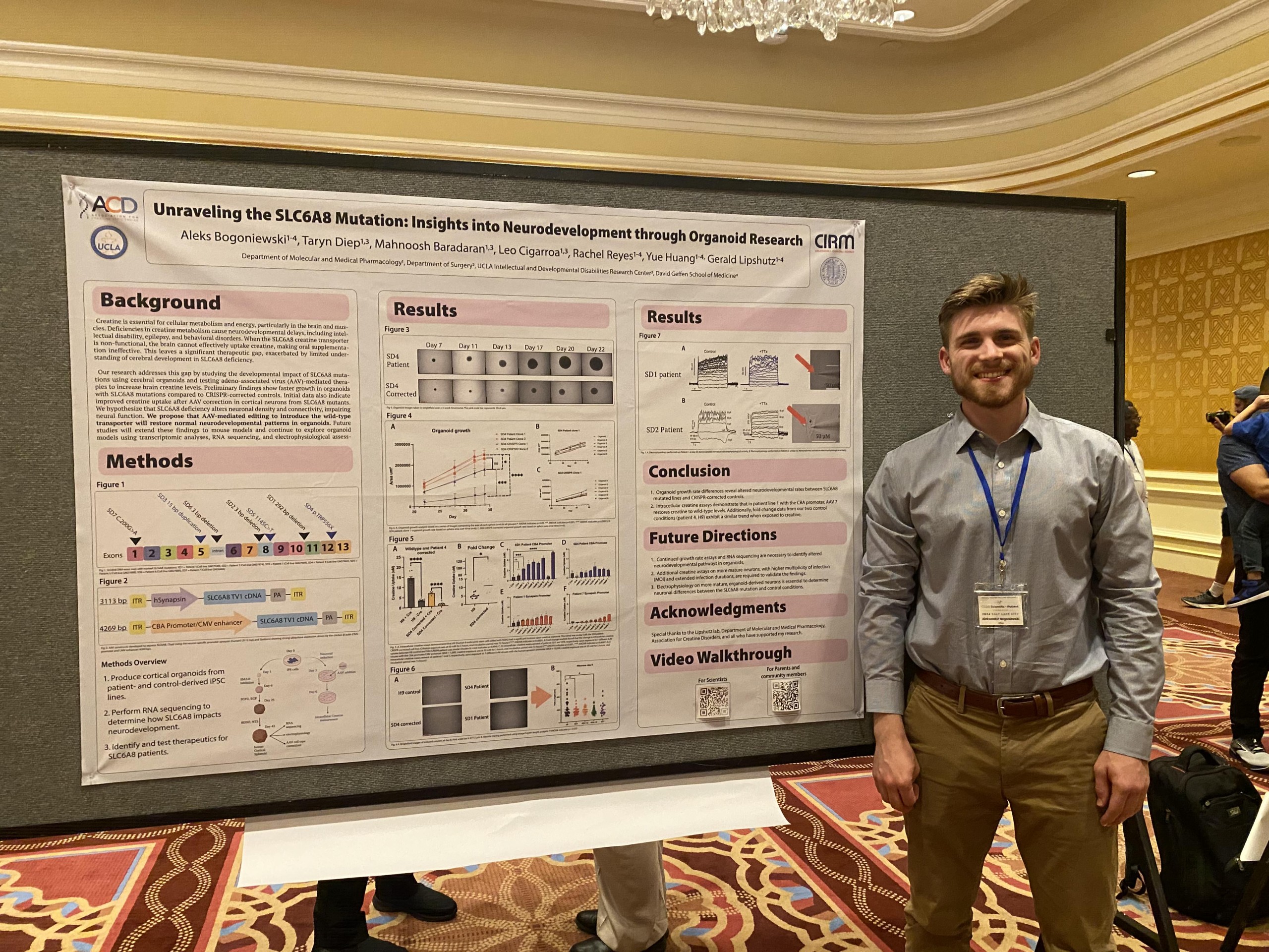 Aleks Bogoniewski posing next to his poster, presenting at the 2024 Cerebral Creatine Deficiency Syndromes (CCDS) Scientific + Patient Symposium